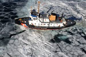 The Coast Guard Cutter Thunder Bay breaks ice in the Straits of Mackinac between Lake Huron and Lake Michigan. (U.S. Coast Guard photo)