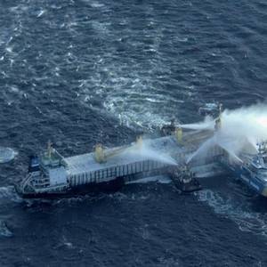Fire Rages on Cargo Ship Carrying Timber Off Sweden