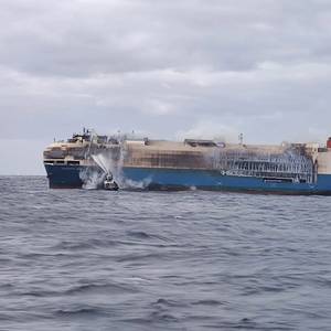 Tug Boats Spray Water on Blazing Ship Carrying Luxury Cars near Azores