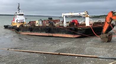 The Coast Guard responds to a fuel barge that sett