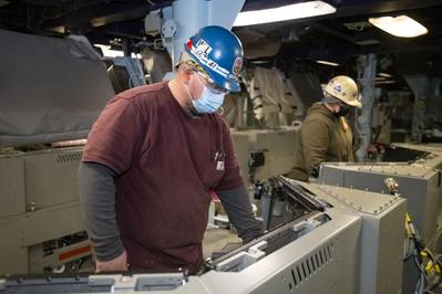 Ingalls Shipbuilding electrician Joe Ditsworth and electrical foreman Lisa Avery initiate light-off of the Aegis Combat System aboard Jack H. Lucas (DDG 125) in the ship’s combat information center. (Photo: HII)