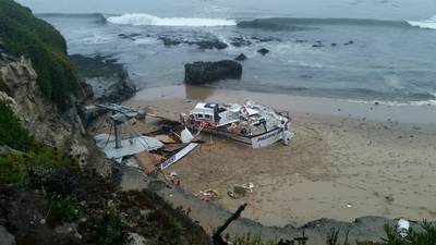 The 56-foot commercial fishing vessel, Pacific Quest, is broken and beached near Seymour Marine Discovery Center in Santa Cruz, Calif., August 13. Responders are working to remove fuel from tanks on the beach during low tide. (U.S. Coast Guard courtesy photo)