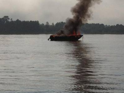 A 17-foot pleasure craft is fully engulfed in flames near Sugar Island on the St. Marys River, Aug. 29, 2013. U.S. Coast Guard photo by Petty Officer 1st Class Joseph Kerr, executive petty officer of Station Sault Ste. Marie.