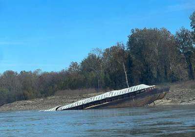 ​A barge that grounded and partially sank following the Marquette Warrior’s loss of steering. (Source: Marquette Transportation Company)