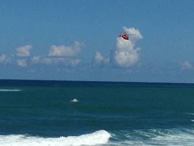 A Coast Guard rescue helicopter crew with Coast Guard Air Station Borinquen, Puerto Rico, flies over a capsized Coast Guard Station San Juan Puerto Rico smallboat off the coast of Puerto Rico Nov. 8, 2013. The smallboat search-and-rescue crew was responding with other local agencies to a report of two people in the water two nautical miles northeast of San Juan Harbor when the vessel capsized. U.S. Coast Guard photo.