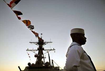 A crew member of the newly commissioned guided missile destroyer USS Sterett (DDG 104) stands at parade rest after being given the order to man the ship and bring her to life by the ship sponsor Michelle Sterett-Bernson. (U.S. Navy photo by Mass Communication Specialist 2nd Class Kevin S. O'Brien/Released)