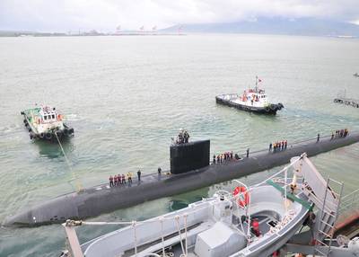 A pair of tug boats pull the Los Angeles-class fast attack submarine USS Santa Fe away from the submarine tender USS Frank Cable after a port visit to Subic Bay, Philippines. Frank Cable conducts maintenance and support of submarines and surface vessels deployed in the U.S. 7th Fleet area of responsibility. (U.S. Navy photo by Petty Officer 1st Class Ricardo Danan)