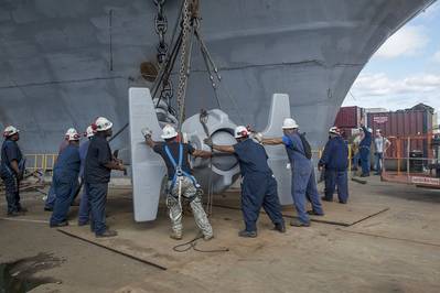 A team of shipbuilders replaces USS Abraham Lincoln’s anchor with one removed from USS Enterprise. Lincoln is undergoing a refueling and complex overhaul at Newport News Shipbuilding at the same time Enterprise is being inactivated. Photo by Ricky Thompson/HII