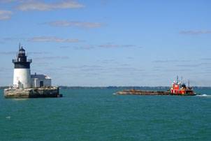 A tug pushes a dredging platform on Lake Erie near Pointe Mouillee, Mich. (Photo courtesy USACE)