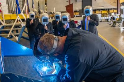 A welder authenticates the keel of Littoral Combat Ship (LCS) 31, the future USS Cleveland, by welding the initials of the ship’s sponsor, Robyn Modly, wife of a Clevelander and former U.S. Navy Secretary, who has embraced the city as her own. (Photo: Lockheed Martin)