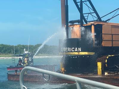 A West Manatee County Fire Department marine unit crew extinguish the fire on a commercial barge after a good Samaritan reported the incident. (U.S. Coast Guard photo)