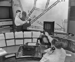Air traffic controllers plot the positions of aircraft on a wall-mounted display, circa 1950. Will control of ships at sea evolve as did air traffic control?