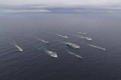 Aircraft carrier HMS Queen Elizabeth has achieved Initial Operating Capability (IOC).
Photo shows HMS Queen Elizabeth and her Carrier Strike Group at an exercise in October 2020: Photo by LPhot Belinda Alker