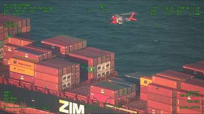 An Air Station MH-60 Jayhawk helicopter hovers over a containership 48 miles east of Virginia Beach, Va. A medevac was requested by the captain of the Zem Shekou after a crew member was found passed out on deck. (U.S. Coast Guard photo)