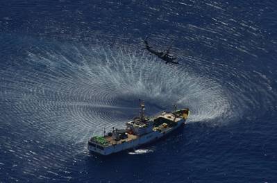 An HH-60G Pave Hawk rescue helicopter from the 129th Rescue Wing hovers over the Chinese fishing vessel Fu Yua (Photo: California Air National Guard).