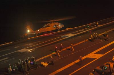 An MH-60S Sea Hawk helicopter from the Red Lions of Helicopter Sea Combat Squadron (HSC) 15 lands on the flight deck of the Nimitz-class aircraft carrier USS Carl Vinson (CVN 70) during search and rescue operations for the pilot of one of two F/A-18 Hornets which crashed earlier in the day while operating from the ship. The other pilot was located and returned to Carl Vinson for medical care. (U.S. Navy photo by John Philip Wagner, Jr.)