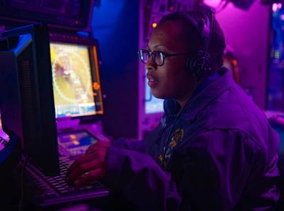 An operations specialist stands watch at the anti-air warfare coordinator console in the combat information center aboard the Arleigh Burke-class guided-missile destroyer USS Gravely. Source: US Navy Petty Officer 1st Class Jonathan Word
