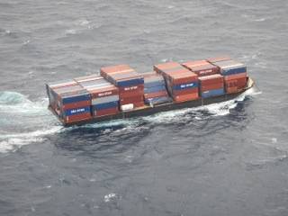 Barge container ship, Columbia Elizabeth, is towed to Port of Palm Beach, Dec. 6, 2015. While enroute to Puerto Rico, several cargo containers fell overboard off the coast of Port Canaveral, Fla. (U.S. Coast Guard photo)