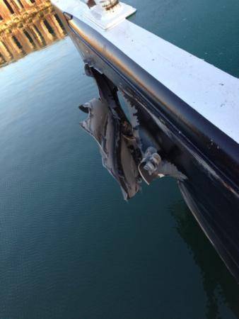 A gash in the hull of a barge is the result of a collision between the tugboats Yellowfin and Capt. Warren that occurred in the Corpus Christi ship channel, Dec. 17, 2013. Coast Guard Sector Corpus Christi has dispatched marine investigators to determine the cause of the collision. (U.S. Coast Guard photo)