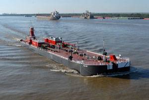 Bouchard’s B. No. 262 and tug Evening Tide navigate down the Mississippi River delivering the barge’s first load of cargo.  B. No. 262 was built and delivered from Bollinger Marine Fabricators.