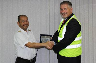 Capt. Guillermo Endozo (left) accepting a commemorative plaque from Gary Lemke, EVP Ports, Abu Dhabi Ports