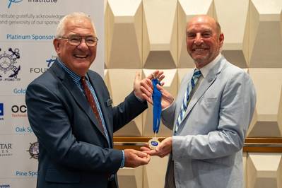 Captain André LeGoubin MNM FNI hands over The Nautical Institute’s Presidential Medallion to Captain Trevor Bailey MNM FNI. (Source: The Nautical Institute)