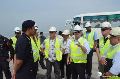 Lt. Cmdr. Carlos Gavilanes (Far Right/Light Blue Shirt), Lt. Cmdr. Kevin Beaudoin (Brown Shirt), Lt. Alejandro Collazo (Light Blue Shirt/Hand Gesture) and Mr. Tivo Romero (Aloha Shirt). (Photo courtesy Penang Port Sdn Bhd.)