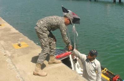 Lt. Carlos Paredes of Dominican Republic Navy welcomes Victor Mooney of Queens, New York to Ocean World Marina in Puerta Plata last week. Mooney has rowed from the coast of Africa and will end his journey in New York City. The rower is honoring his brother who died of AIDS and to promote voluntary HIV testing.