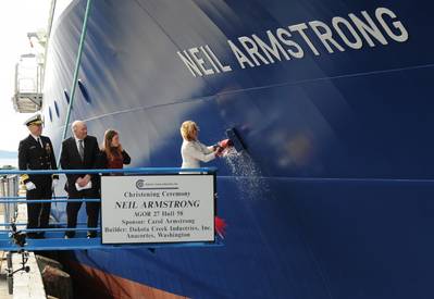 Carol Armstrong, sponsor for the R/V Neil Armstrong , breaks a bottle across bow during a christening ceremony at Dakota Creek Industries, Inc., shipyard in Anacortes, Wash. Joining Carol on the platform are Rear Adm. Matthew Klunder, left, chief of naval research, Dick Nelson, president, Dakota Creek Industries, Inc., and Kali Armstrong, granddaughter of the late astronaut. (U.S. Navy photo by John F. Williams)