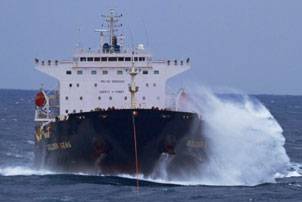 The bulk carrier Golden Seas is towed through rough seas in the Bering Sea by the Tor Viking II Dec. 5, 2010. Photo courtesy of Tor Viking II