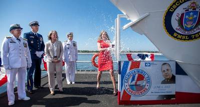 Christina Calhoun Zubowicz, ship sponsor and granddaughter of the namesake, christened the ship by breaking a bottle of sparkling wine across the bow.- Credt: HII