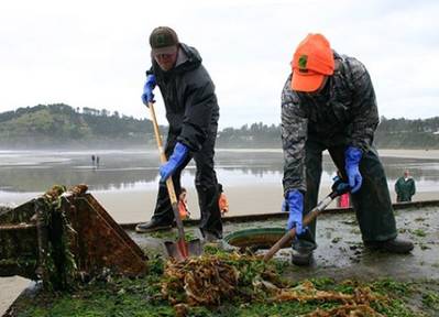 Clearing beached Japan Tsunami debris: Photo credit NOAA