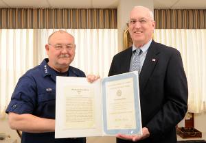 Coast Guard Commandant, Adm. Thad Allen, presents Peter Kennedy with a Meritorious Public Service Award during an awards ceremony at Coast Guard Headquarters, March 19, 2010. Kennedy, a member of the Orleans Historical Society, was recognized for his work in replicating Coast Guard Motorlifeboat 36500 for use as a floating museum, and for preserving Coast Guard history. U.S. Coast Guard photo by Petty Officer 2nd Class Luke Pinneo.