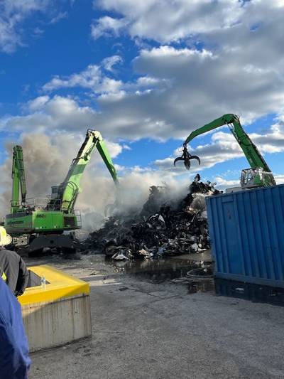 Commercial salvage excavators work to overhaul scrap metal that caught fire aboard a barge in the Newark Harbor on Oct. 22 2023. Coast Guard pollution responders supervise the operation to limit the opportunity of pollution entering the water. (Photo courtesy of Ken's Marine)