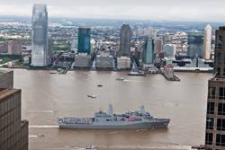 Crew members aboard the amphibious transport dock ship USS New York (LPD 21) man the rails and present honors while passing The World Trade Center and the National September 11 Memorial and Museum as the ship arrives in Manhattan. (U.S. Marine Corps photo by Sgt. Randall A. Clinton/Released) 