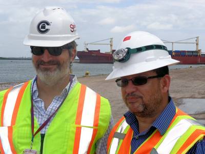Crowley's Bleu Hilburn and Tony Ortiz in front of the company's chartered ship Vega (Photo courtesy of Crowley Maritime Corp.)
