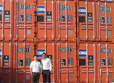 Daniel Lim and Sahil Gandhi (L to R) in front of a line of OEG Containers