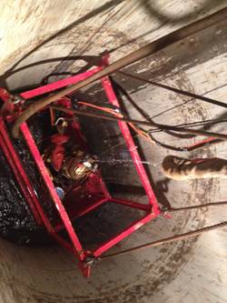 Divers, working in a man basket, were lowered into 7 foot diameter casing to the various depths of work, from 120 feet to 170 feet.