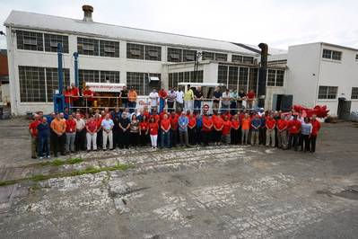 Ellicott employees gather at the company’s Baltimore plant following a celebratory lunch in front of a Series 370 Dragon dredger (Photo: Ellicott Dredges)