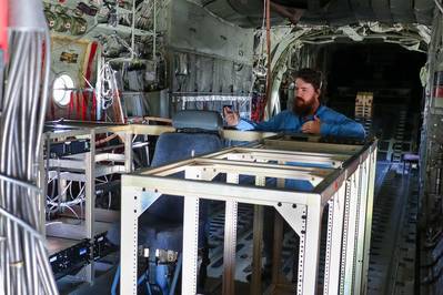 VX-30 engineer Sam Newcomer explains the Satellite Communications Range Extension Aircraft Modification (SCREAM) system inside a KC-130T Hercules at Naval Base Ventura County. The system enabled beyond-line-of-sight communications during Exercise Talisman Sabre 2025, supporting the U.S. Army’s first Typhon missile launch outside the continental United States. (U.S. Navy photo by Michael L. Smith)