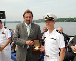 Ensign Jeffrey Iiams receives the Elmer A. Sperry Junior Navigator of the Year Award from Jeff Holloway of Northrop Grumman Corporation.
