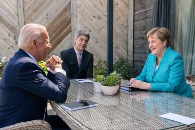 File photo: President Joe Biden meets for a brief pull-aside meeting with German Chancellor Angela Merkel during the G7 Summit at the Carbis Bay Hotel and Estate on Saturday, June 12, 2021, in St. Ives, Cornwall, England. (Official White House Photo by Adam Schultz)