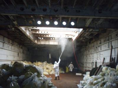 File photo: Workers clean the interior of a cargo hold aboard the LST-1166. (U.S. Coast Guard photo/Pacific Strike Team)