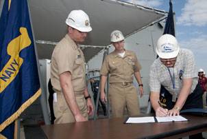 ith U.S. Navy Capt. Bill Galinis, supervisor of shipbuilding, Gulf Coast, far left and U.S. Navy Cmdr. Thomas R. Williams, DDG 110's prospective commanding officer, center, observing, George Nungesser, Northrop Grumman Shipbuilding program manager for the DDG 51 program, signs the DD250 form officially transferring custody of William P. Lawrence (DDG 110) from Northrop Grumman to the Navy. Photo courtesy Northrop Grumman.