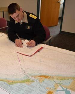 Rear Adm. Gerd Glang certifies a new print-on-demand chart agent after inspecting the company's sample chart. (Photo: NOAA)