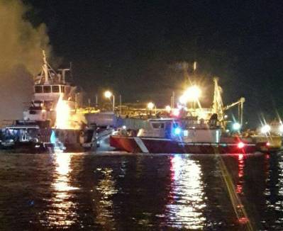 Houston Marine Fire Department boat on scene after a tug boat that was moored caught fire around 2 a.m., Feb. 26, 2016. U.S. Coast Guard Station Houston boat crews established a safety zone to assist in firefighting efforts. (USCG photo by Joseph Mccune)