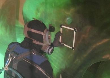 A Hydrex diver/technician works on a propeller under water