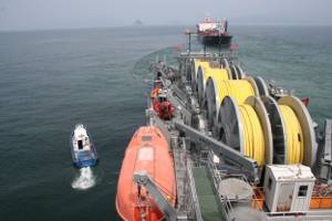 In 2009, the Military Sealift Command offshore petroleum distribution system ship MV Vice Adm. K.R. Wheeler (foreground) and Military Sealift Command tanker USNS Lawrence H. Gianella (background) practice running a float hose between the two ships during a one-day exercise off the coast of Yeosu, South Korea. (U.S. Navy photo by Edward Baxter, taken off Yeosu, South Korea on Aug. 18, 2009)