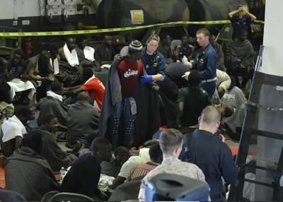 In the Mediterranean Sea in 2014, Lt. Kathleen Kostka, from Memphis, Tenn., and Lt. John Yosay, from Boardman, Ohio, both attached to Fleet Surgical Team 4, provide medical attention to migrants aboard the multipurpose amphibious assault ship USS Bataan (LHD 5).  (U.S. Navy photo by Mass Communication Specialist 1st Class Julie Matyascik/Released)