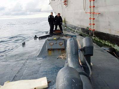In this photo released by the U.S. Coast Guard, members of U.S. Coast Guard law enforcement detachment 404 survey the deck of the self-propelled, semi-submersible craft seized Saturday, Sept. 13, 2008, by the guided-missile frigate USS McInerney (FFG 8). The Coast Guard law enforcement officers, embarked aboard the McInerney, seized the estimated $187 million worth of cocaine during a night raid about 350 miles west of Guatemala.